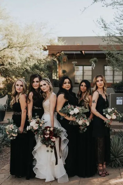 mismatching black maxi and midi bridesmaid dresses of lace and plain fabric and black shoes for Halloween