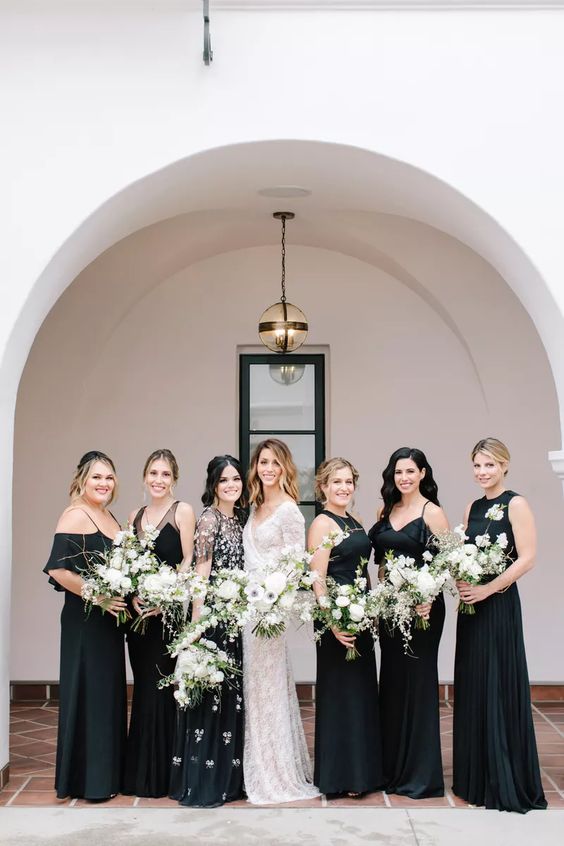 mismatching black maxi bridesmaid dresses including a floral applique one are amazing for a cool and chic wedding