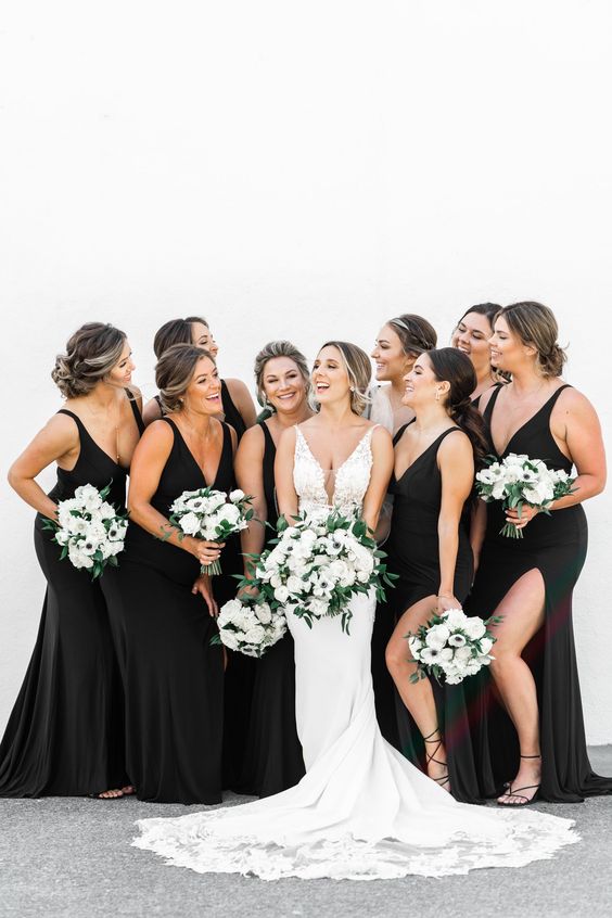 pretty and chic black mermaid bridesmaid dresses with side slits and strappy black shoes for a chic and sexy look