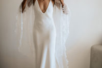 02 The bride was wearing a plain spaghetti strap wedding dress with a plunging neckline and an ethereal coverup
