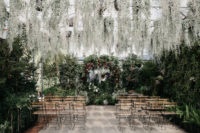wedding ceremony covered with greenery
