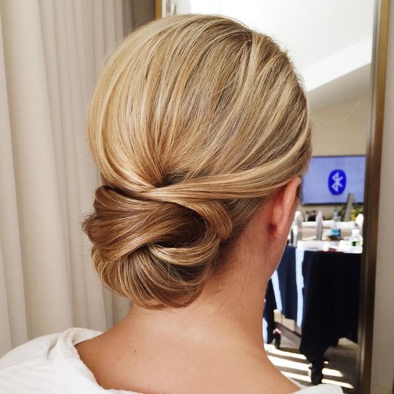 a chic tight low bun with twists will last all day long and will fit even the most formal style