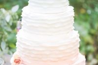 02 a subtle ombre ruffle wedding cake fro white to blush and with peachy blooms for decor