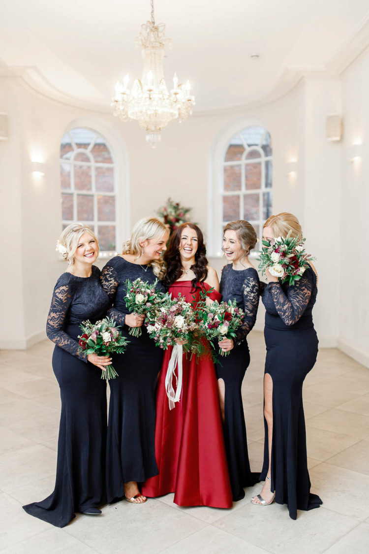 The bridesmaids were wearing navy maxi dresses with lace bodices and sleeves and side slits