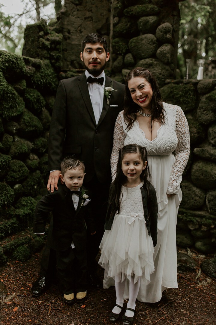 The groom and their son chose black tuxedos and the daughter was rocking a white dress and a dark cardigan