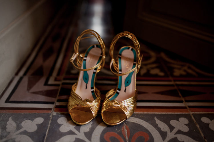 Here are the bride's Gucci gold heels with snakes printed inside
