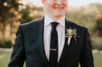 04 The groom was wearing a black suit with a black tie plus a floral boutonniere