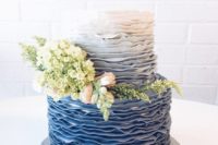 04 a chic ombre blue wedding cake decorated with real blooms and greenery is a trendy idea