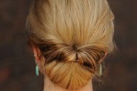 04 a low bun with a twist and a messy top for a refined and effortless look
