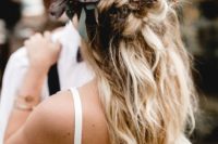 04 a messy textural half updo with twists and braids and greenery and feathers