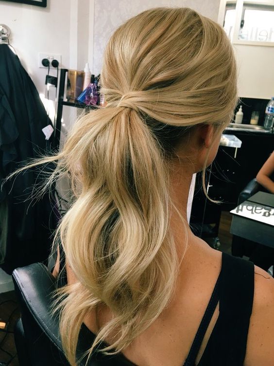 a simple and cute low ponytail with waves, locks down and a bump on top