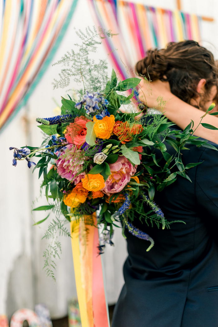 The bridal bouquet was a bold one, with blooms of different shades and colorful ribbons