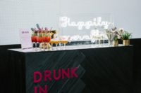 05 an ultra-modern wedding cocktail bar with an acrylic calligraphy sign, blooms and pink letters