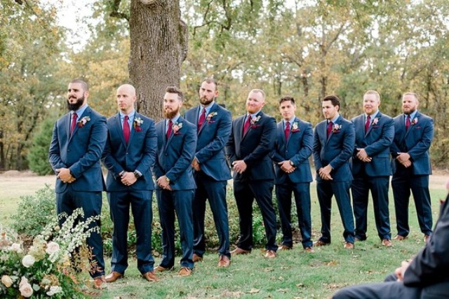 The groomsmen were rocking navy suits with blue shirts and bold plum-colored ties