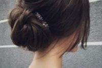 06 a messy low bun with a bump and some textural hair down plus a rhinestone hairpiece for an effortlessly chic look