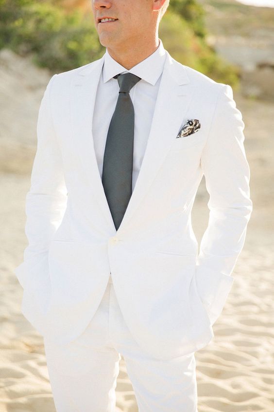 a pure white wedding suit with a white shirt and a grey tie for a touch of color