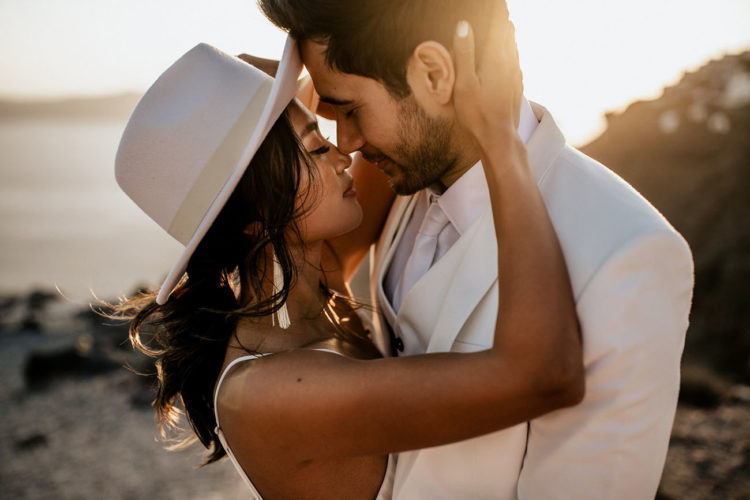 The bride rocked trendy tassel earrings and a white hat for a boho feel