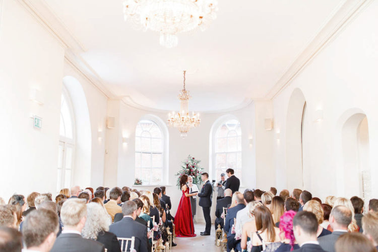The ceremony space was all-white, with glam chandeliers and a large floral decoration