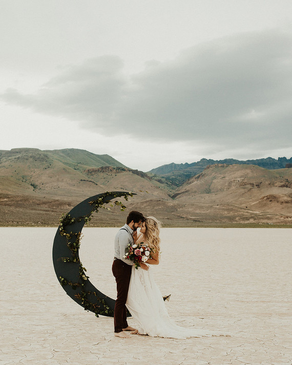 The wedding altar was a dark crescent moon decorated with fresh greenery