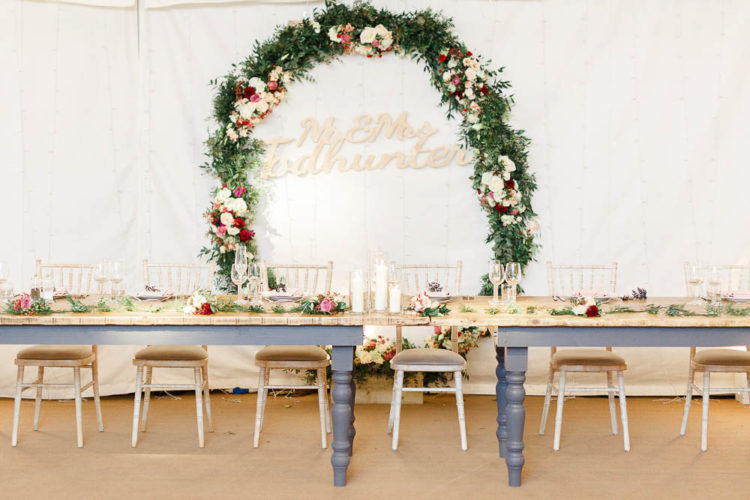The reception space was done with rustic touches, bold blooms, greenery and many candles