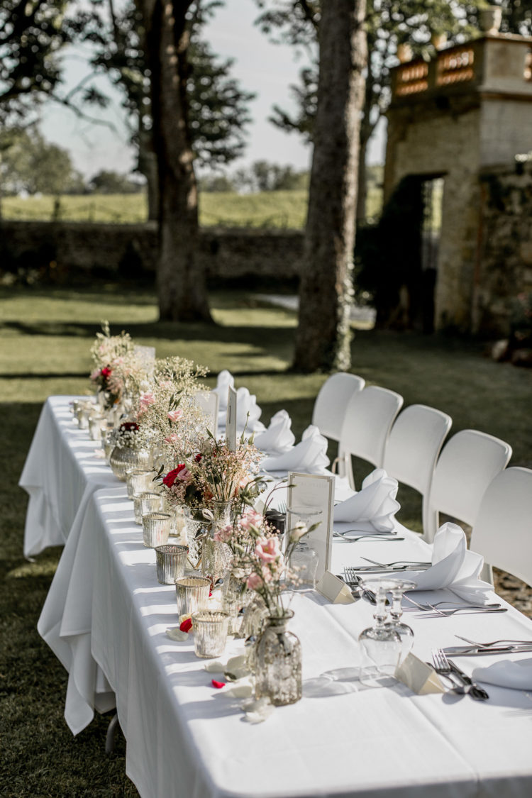 The wedding reception tables were done with delicate florals, white textiles and mercury glass vases and candle holders