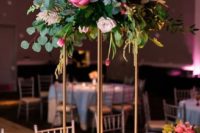 08 a gorgeous tall centerpiece with pink and blush blooms, craspeadia, greenery on a brass stand with candles around