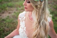 08 a textural half updo with a side fishtail braid and a greenery and succulent crown for a boho bride