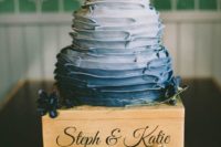 08 an ombre white to navy ruffle wedding cake topped with berries and dark blooms
