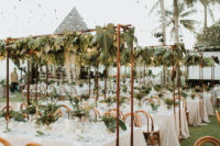 09 The centerpieces were paired with cascading greenery over the tables to make the venue feel as fresh as possible