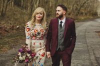 09 a sheath wedding dress with colorful floral embroidery, burgundy suede boots and a red lip