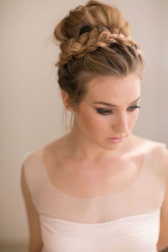 a top knot hairstyle with a braid around is a freah take on a usual one