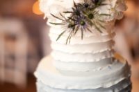 09 an ombre white to grey ruffle wedding cake topped with white hydrangeas and blue thistles