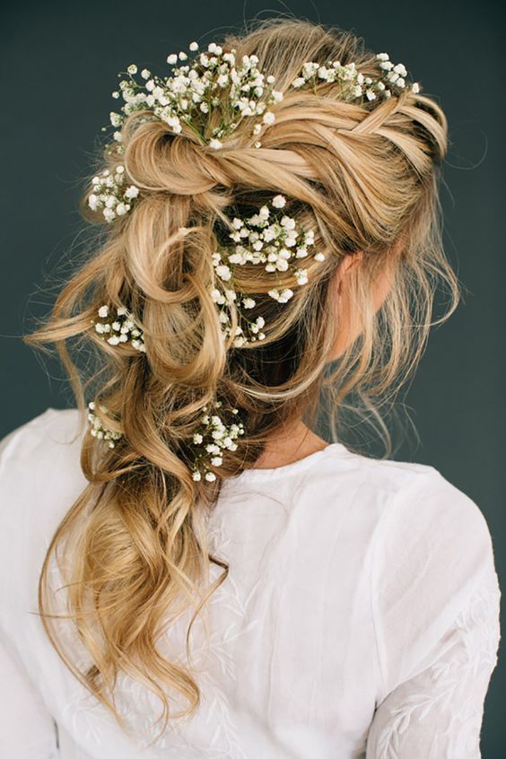 romantic tousled bridal braid adorned with baby's breath looks ethereal