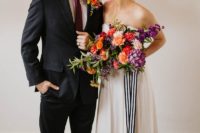 10 The groom was wearing a black suit, a burgundy tie and a colorful floral boutonniere