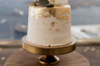 10 The wedding cake is a white one with gold leaf, topped with a white orchid