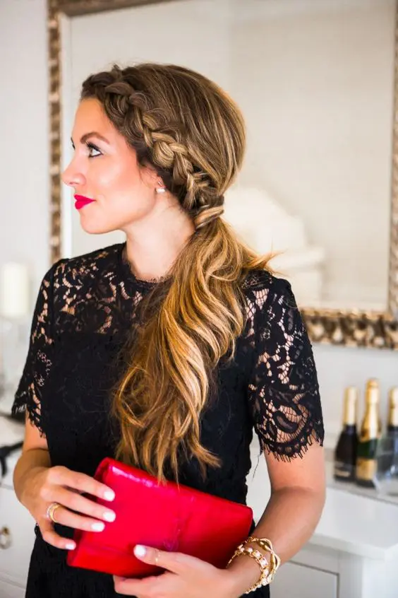 a Dutch braid ponytail with waves and a bump is a cool and feminine idea for a hairstyle