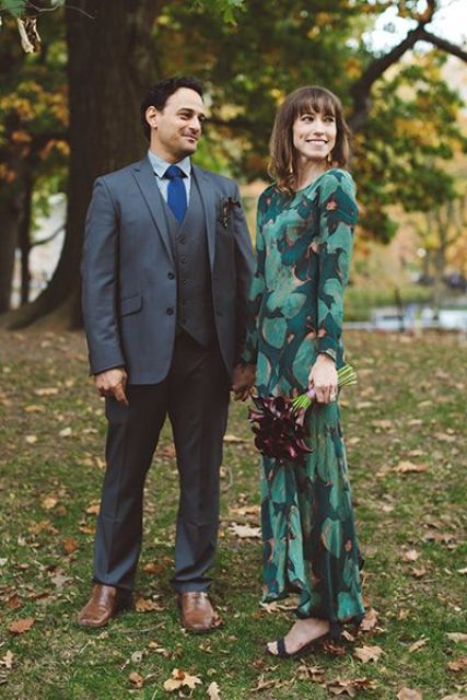 a dark green wedding dress with an emerald leaf print and long sleeves and dark green shoes for a fall look