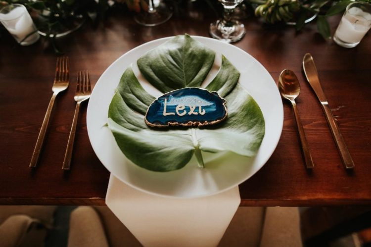 The place settings were done with tropical leaves and agate slice cards