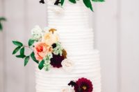 11 The wedding cake was a buttercream one topped with bold blooms for decor