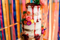 11 The wedding cake was a naked one with strawberry compote drip and bright blooms
