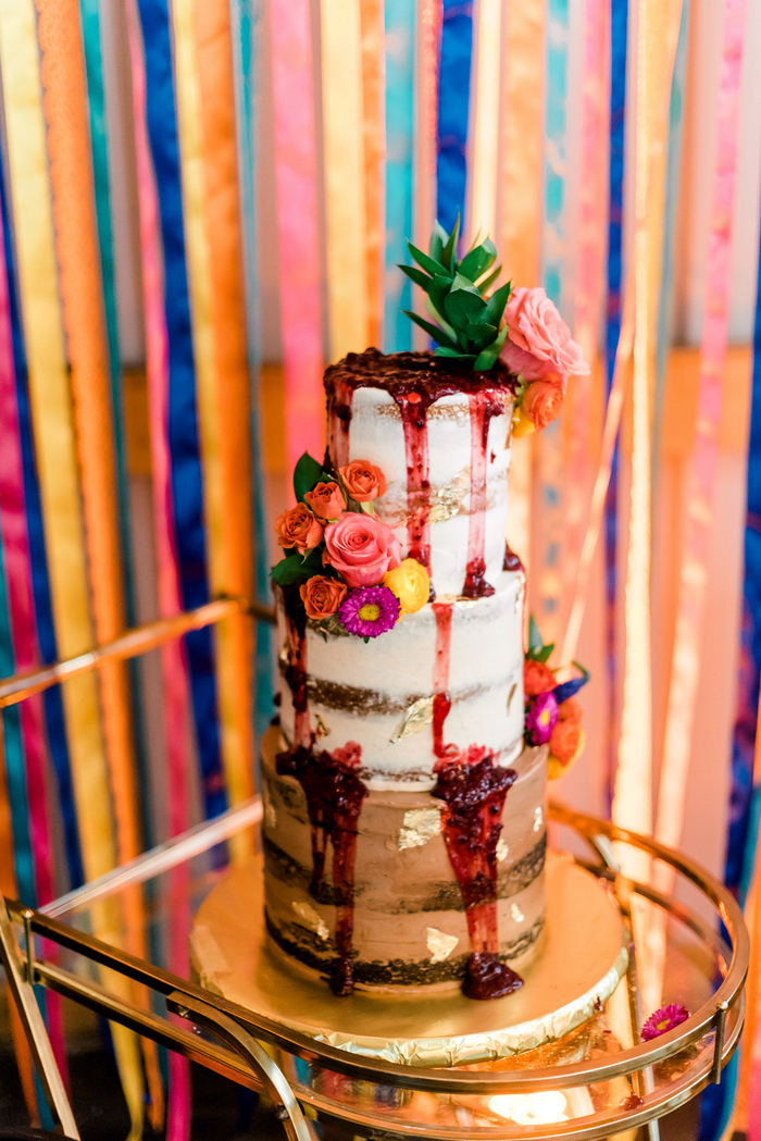 The wedding cake was a naked one with strawberry compote drip and bright blooms
