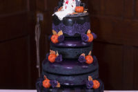 11 The wedding cake was done in black and purple, with orange accents and cool toppers
