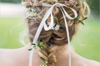 11 a braid with some curls and some blooms and greenery plus a thin ribbon