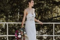 11 a simple plain strapless sheath wedding dress with a draped bodice and statement earrings for a bold touch