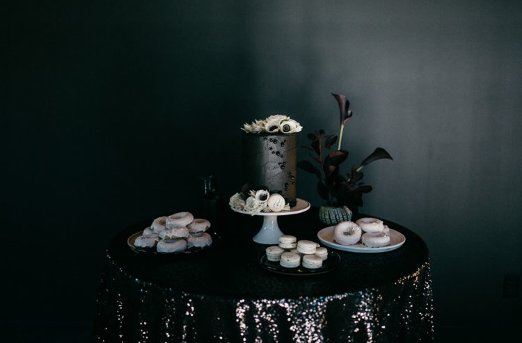 The dessert table also included cream macarons and white glaze donuts