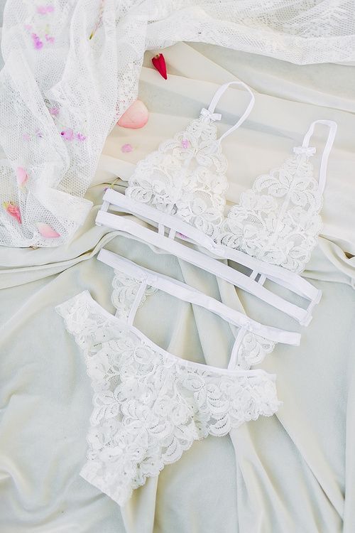 a lace bridal lingerie set with a strappy bra, panties and a stocking belt