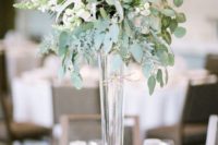 12 a modern tall centerpiece with a tall gold foil vase, eucalyptus, bluhs roses, herbs and air plants