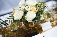 13 a black and white tablescape is spruced up with a gold sequin table runner for a bold touch
