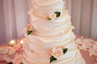 13 a cute neutral wedding cake with textural large ruffles and sugar blooms all over