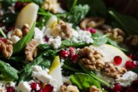 13 a salad with sweet pears, feta cheese, crunchy pomegranates, walnuts and spinach plus orange juice